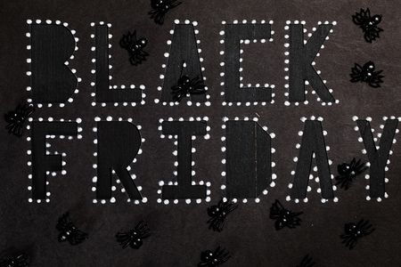 Words BLACK FRIDAY are cut out from black carton paper. Closeup.の写真素材