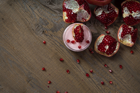 Pomegranate body cream on a wooden surface. Closeupの写真素材