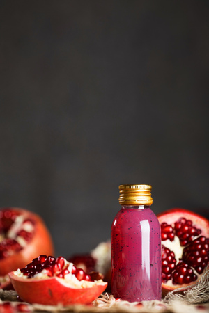 Glass of pomegranate seed body scrub on a wooden surface. Closeupの写真素材