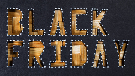 Words BLACK FRIDAY are cut out from black carton paper. Closeup.の写真素材