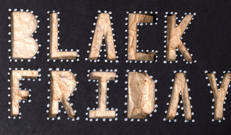 Words BLACK FRIDAY are cut out from black carton paper. Closeup.の写真素材