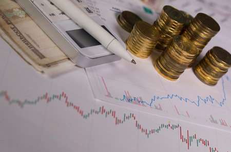 Pen on calculator. Coins of ten roubles in the background. Closeupの写真素材