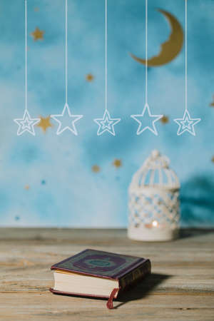 Sacred book of Quran on a wooden surface.の写真素材