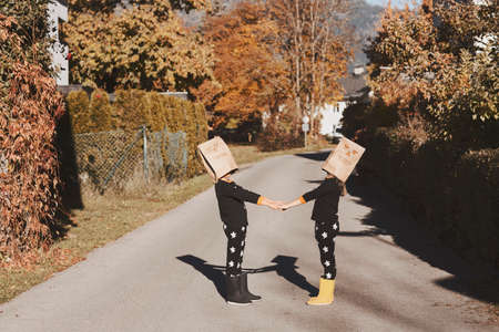 Two kids in Halloween pyjamas are playing togetherの写真素材