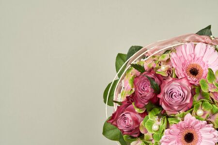 Beautiful flowers bouquet with rose and gerberas on plain color background
