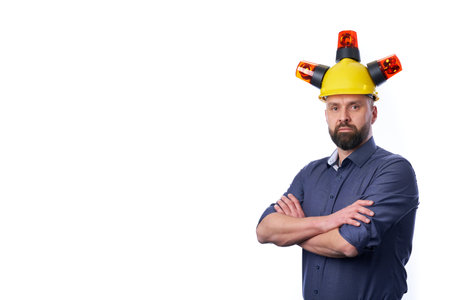 unshaven businessman wearing yellow protective construction helmet.の写真素材