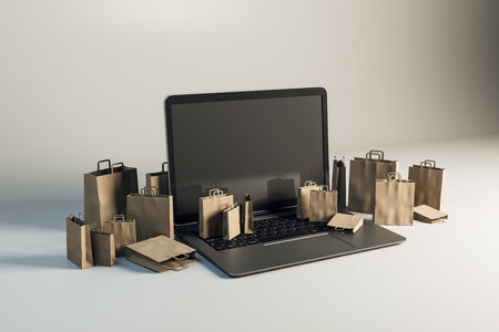 Empty laptop with tiny shopping bags on gray background. Online shopping and commerce concept. Mock up, 3D Rendering の写真素材