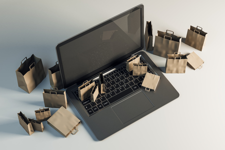 Empty laptop with tiny shopping bags on gray background. Online shopping and computer concept. Mock up, 3D Rendering の写真素材