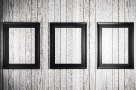 three black picture frames on light wooden wall. 3D rendering