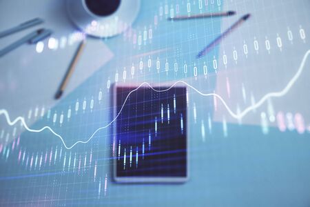 Double exposure of forex graph on digital tablet laying on table background. Concept of market analysisの写真素材