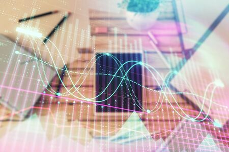 Double exposure of forex graph on digital tablet laying on table background. Concept of market analysisの写真素材