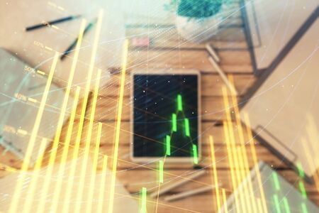 Double exposure of forex graph on digital tablet laying on table background. Concept of market analysisの写真素材