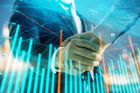 Double exposure of financial chart on cityscape background with two businessmen handshake. Concept of financial analysis and investment opportunitiesの写真素材