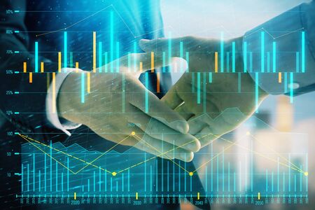 Double exposure of financial graph on cityscape background with two businessman handshake. Concept of stock market dealの写真素材