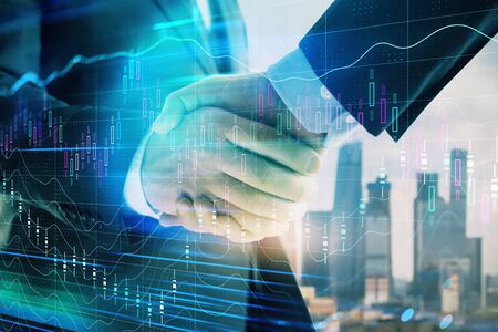 Double exposure of financial graph on cityscape background with two businessman handshake. Concept...