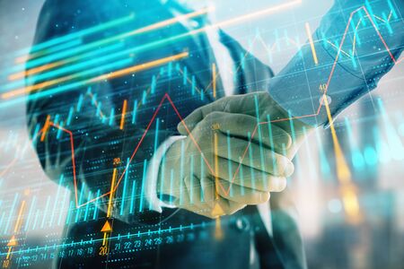 Double exposure of financial graph on cityscape background with two businessman handshake. Concept of stock market dealの写真素材