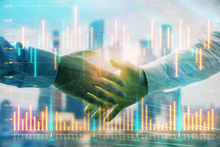 Double exposure of financial graph on cityscape background with two businessman handshake. Concept of stock market dealの写真素材