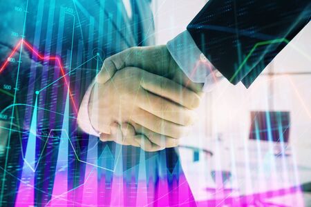 Multi exposure of financial graph on office background with two businessmen handshake. Concept of success in businessの写真素材