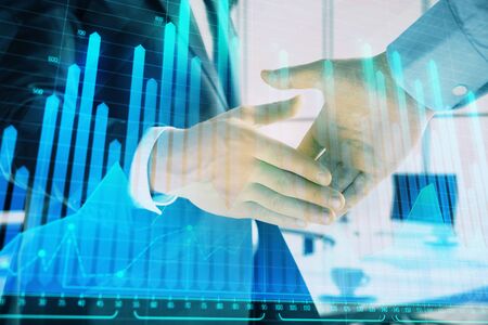 Multi exposure of financial graph on office background with two businessmen handshake. Concept of success in businessの写真素材