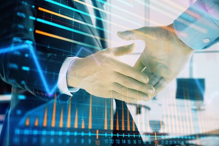 Multi exposure of financial graph on office background with two businessmen handshake. Concept of success in businessの写真素材