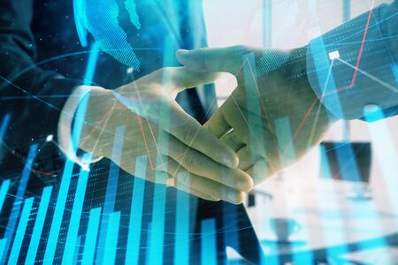 Multi exposure of financial chart and map on office background with two businessmen handshake. Concept of success in businessの写真素材