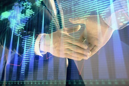 Multi exposure of forex graph and world map on abstract background with two businessmen handshake. Concept of success on international marketsの写真素材
