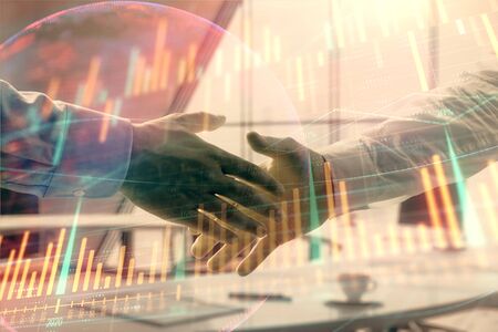 Multi exposure of financial chart and map on office background with two businessmen handshake. Concept of success in businessの写真素材