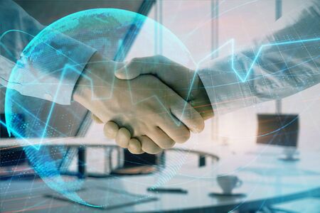 Multi exposure of financial chart and map on office background with two businessmen handshake. Concept of success in businessの写真素材