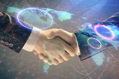 Multi exposure of world map on abstract background with two businessmen handshake. Concept of international businessの写真素材
