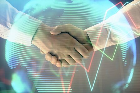 Multi exposure of forex graph and world map on abstract background with two businessmen handshake. Concept of success on international marketsの写真素材