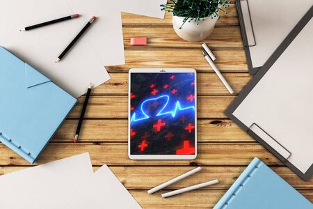 Digital tablet closeup top view with human heart drawing on screen. Medical education concept. 3d rendering.の写真素材