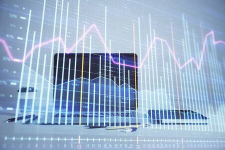 Forex graph hologram with desktop office computer background. Double exposure. Concept of financial analysis.の写真素材