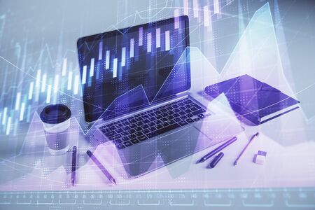 Forex graph hologram with desktop office computer background. Double exposure. Concept of financial analysis.の写真素材