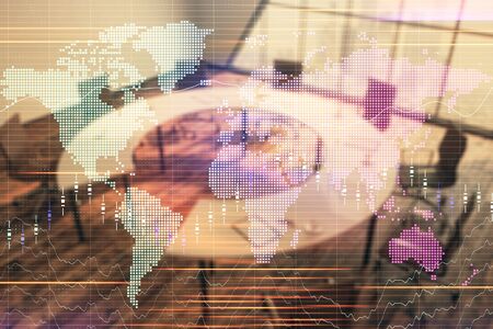Double exposure of stock market graph with globe hologram on conference room background. Concept of international financeの写真素材