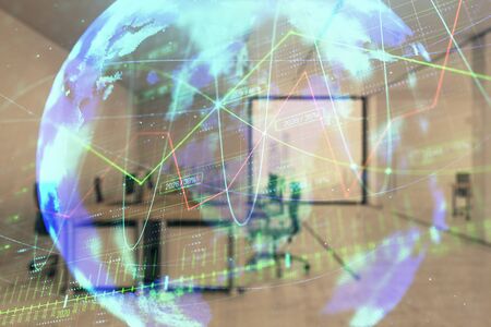 Stock and bond market graph and world map with trading desk bank office interior on background. Multi exposure. Concept of international financeの写真素材