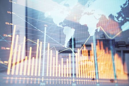 Stock and bond market graph and world map with trading desk bank office interior on background. Multi exposure. Concept of international financeの写真素材
