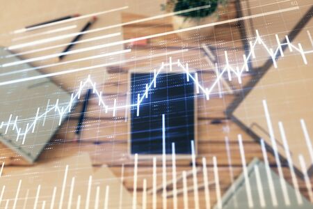 Double exposure of forex graph on digital tablet laying on table background. Concept of market analysisの写真素材