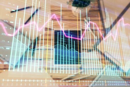 Double exposure of forex graph on digital tablet laying on table background. Concept of market analysisの写真素材