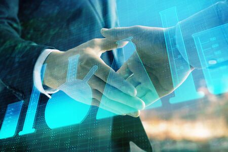 Double exposure of chemistry theme hologram on city view background with handshake. Concept of educationの写真素材