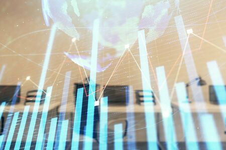 Stock and bond market graph and world map with trading desk bank office interior on background. Multi exposure. Concept of international financeの写真素材
