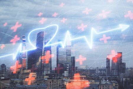 Multi exposure of human heart hologram on Moscow cityscape background. Concept of medical educationの写真素材