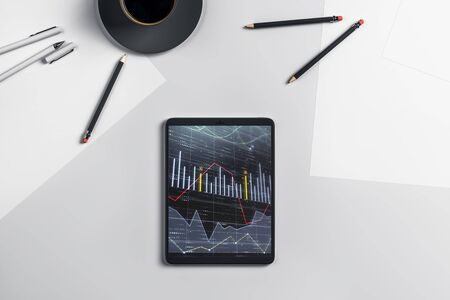 Digital tablet closeup top view with financial graph on screen. Online trading application concept. 3d rendering.の写真素材