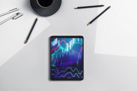 Digital tablet closeup top view with financial graph on screen. Online trading application concept. 3d rendering.の写真素材