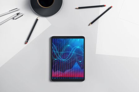 Digital tablet closeup top view with financial graph on screen. Online trading application concept. 3d rendering.の写真素材