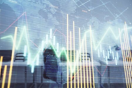 Stock and bond market graph and world map with trading desk bank office interior on background. Multi exposure. Concept of international financeの写真素材