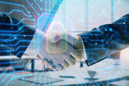 Double exposure of lock icon hologram on office background with two men handshake. Concept of data...