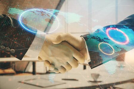 Multi exposure of world map on office background with two businessmen handshake. Concept of international businessの写真素材