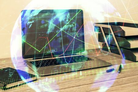 Stock market chart with globe hologram and desktop office computer background. Multi exposure. Concept of financial analysis.の写真素材