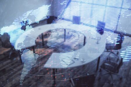 Double exposure of globe hologram on conference room background. Concept of international businessの写真素材