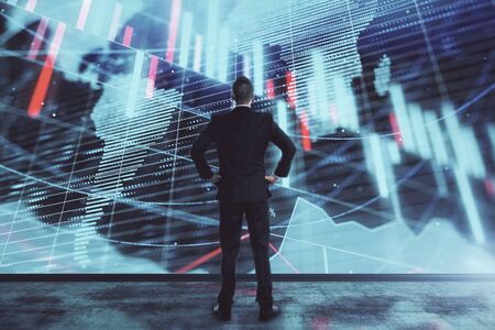 Businessman and forex graph and world map hologram. Double exposure. Concept of financial education...
